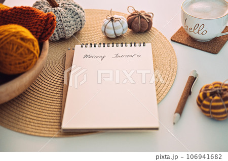 Morning Journal, Journaling Techniques Tips for Writing Morning Pages. Open notebook with text Morning Journal, coffee cup, pen and decor on table Morning Journal, Journaling Techniques Tips for Writing Morning Pages. Open notebook with text Morning Journal, coffee cup, pen and decor on table 106941682