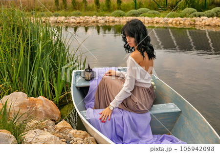 Beautiful young caucasian woman sitting on a boat. 106942098