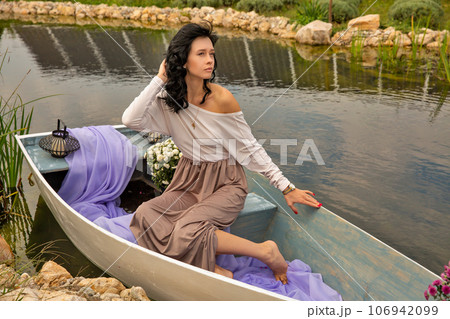 Beautiful young caucasian woman sitting on a boat. 106942099