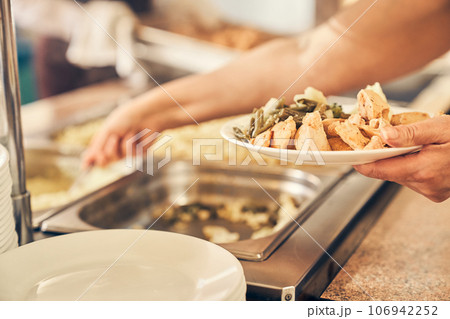 A hand serving food to the homeless. People receiving donations from a good friend, the concept of careful giving. High quality photo A hand serving food to the homeless. People receiving donations from a good friend, the concept of careful giving. High quality photo 106942252