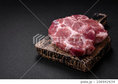 Fresh juicy pork steaks with salt, spices and herbs Fresh juicy pork steaks with salt, spices and herbs 106942634