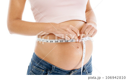Pregnancy, measuring tape and woman stomach in studio to check growth, development and health on mockup. Abdomen, wellness and pregnant woman self care, diet and healthy progress on white background 106942810