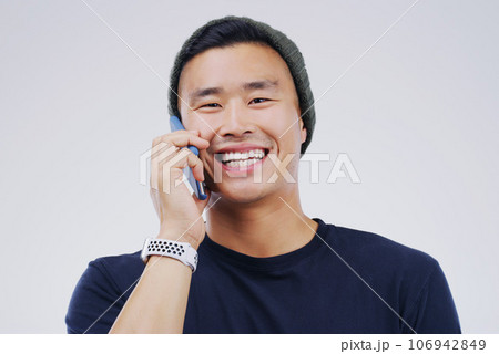 Phone call, funny and portrait of Asian man talking in studio isolated on white background. Cellphone, laughing and face of male person in communication, speaking or discussion, comedy or comic meme. Phone call, funny and portrait of Asian man talking in studio isolated on white background. Cellphone, laughing and face of male person in communication, speaking or discussion, comedy or comic meme. 106942849