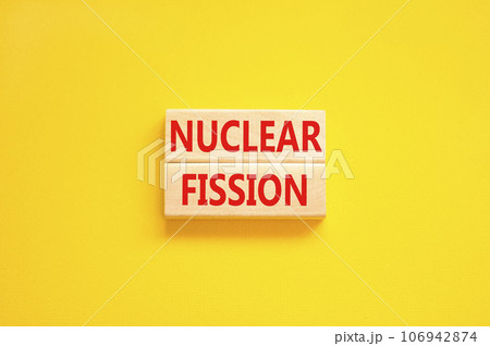 Nuclear fission symbol. Concept words Nuclear fission on beautiful wooden blocks. Beautiful yellow table yellow background. Business science nuclear fission concept. Copy space. 106942874