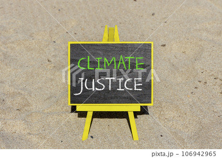 Climate justice symbol. Concept words Climate justice on beautiful black chalk blackboard. Chalkboard. Beautiful sand background. Business environment climate justice concept. Copy space. 106942965