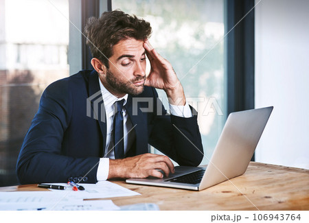Tired, laptop and stress businessman lazy with a headache in an office typing on a computer online or the internet. Sleepy, burnout and depressed male corporate person writing a report or research Tired, laptop and stress businessman lazy with a headache in an office typing on a computer online or the internet. Sleepy, burnout and depressed male corporate person writing a report or research 106943764