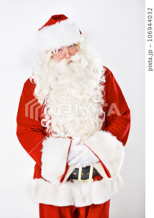 Portrait of father Christmas in studio with white background in a red costume for Christian winter holiday celebration. Marketing, senior or santa claus face with sales offer, promo or discount deals 106944032