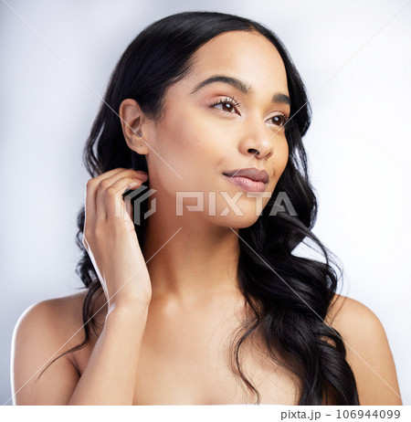 Beauty, makeup and face of woman in studio for natural, cosmetics and glow. Smile, self care and hairstyle with young female model on white background for skincare, wellness and facial 106944099