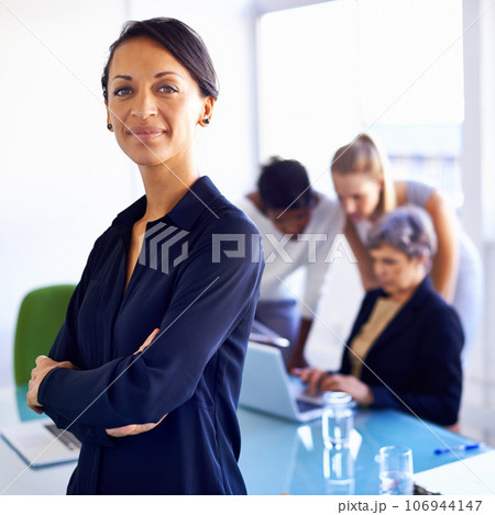 Ive got confidence in my team. Portrait of a businesswoman standing in front of her colleagues during a meeting. Ive got confidence in my team. Portrait of a businesswoman standing in front of her colleagues during a meeting. 106944147