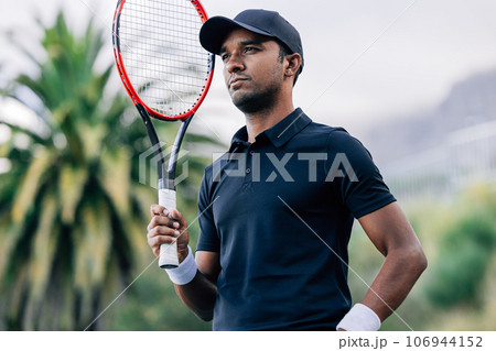 Portrait of a young tennis player with a racket 106944152