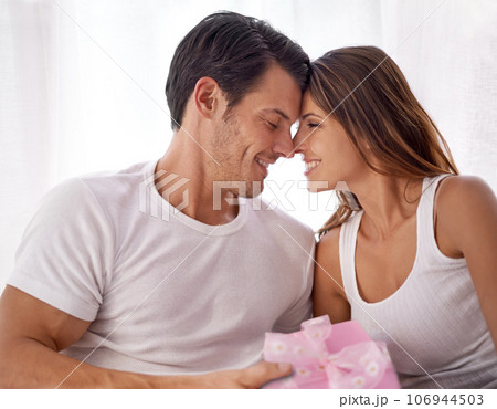 Man giving woman present, love and happy with partnership, relationship and celebration on Valentines day date. Couple smile with gift box, luxury and commitment, gratitude and celebrate holiday 106944503