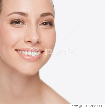 Smile, dental care and portrait of a woman with skincare isolated on a white background in studio. Happy, face and a young model showing teeth for oral hygiene with grooming for care of skin Smile, dental care and portrait of a woman with skincare isolated on a white background in studio. Happy, face and a young model showing teeth for oral hygiene with grooming for care of skin 106944511