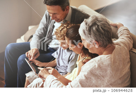 Tablet, children or grandparents streaming movie or film on online subscription in retirement at home together. Kids siblings, relaxing or grandmother loves watching fun videos with a senior old man Tablet, children or grandparents streaming movie or film on online subscription in retirement at home together. Kids siblings, relaxing or grandmother loves watching fun videos with a senior old man 106944628