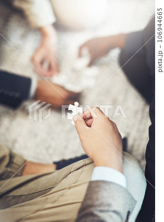 Businessman, hands and puzzle piece in team building, meeting or problem solving together at office. Hand of man person in teamwork, jigsaw activity or collaboration for project together at workplace Businessman, hands and puzzle piece in team building, meeting or problem solving together at office. Hand of man person in teamwork, jigsaw activity or collaboration for project together at workplace 106944665