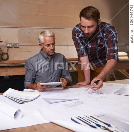 Architecture men, planning and blueprint with tablet for discussion, construction or vision in workshop. Senior man, young male partner and talking with paperwork, property or real estate development 106944743