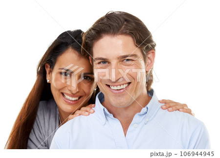 Love, hug and portrait of a couple in a studio for valentines day, romance or anniversary. Happy, smile and young interracial man and woman embracing with happiness isolated by a white background. 106944945
