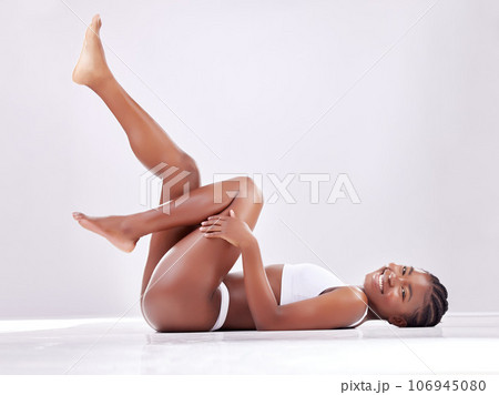 Skincare, legs and portrait of black woman on studio floor for shaving, hair grooming and wellness. Beauty, underwear and female person on white background for cosmetics, natural skin or body care Skincare, legs and portrait of black woman on studio floor for shaving, hair grooming and wellness. Beauty, underwear and female person on white background for cosmetics, natural skin or body care 106945080