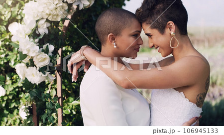 Love, hug and lgbtq with lesbian couple at wedding for celebration, gay and pride. Smile, spring and happiness with women kiss at marriage event for partner commitment, sexuality and freedom 106945133