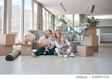 Moving, box and portrait of family in new house for property, investment or future. Real estate, happy and renting with parents and children in living room of home for relocation, homeowner and relax 106945134
