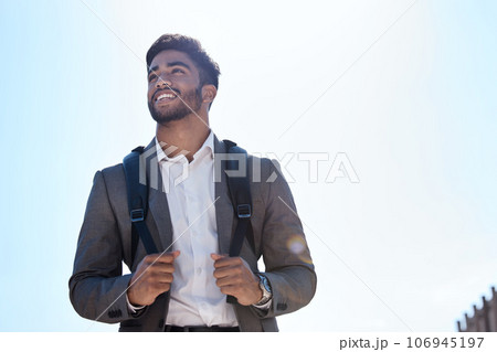 Business man, backpack and walking in street, city and summer sunshine with smile with vision. Young indian businessman, outdoor and walk with happiness, thinking and professional in metro for travel 106945197