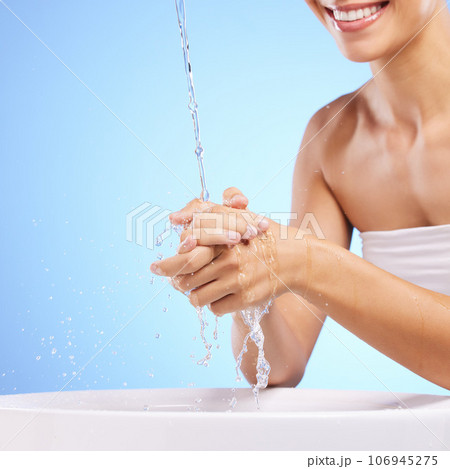 Water, happy woman or washing hands in studio on blue background for wellness or skincare hydration. Healthcare, mouth smile zoom or girl cleaning with liquid splash in hygiene or bacteria prevention Water, happy woman or washing hands in studio on blue background for wellness or skincare hydration. Healthcare, mouth smile zoom or girl cleaning with liquid splash in hygiene or bacteria prevention 106945275