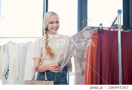 This is just what I was looking for. Shot of a young woman shopping for clothes in a store. This is just what I was looking for. Shot of a young woman shopping for clothes in a store. 106945307