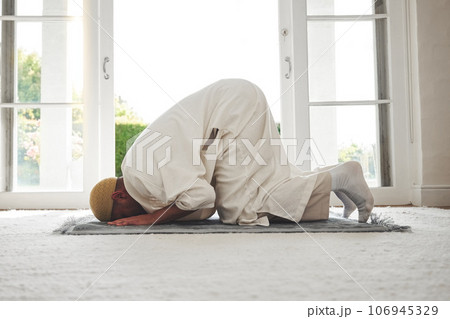Prayer, muslim and islamic with man on living room floor for eid mubarak, God and worship. Quran, hope and Ramadan with spiritual person praying on mat at home for faith, religion and gratitude Prayer, muslim and islamic with man on living room floor for eid mubarak, God and worship. Quran, hope and Ramadan with spiritual person praying on mat at home for faith, religion and gratitude 106945329