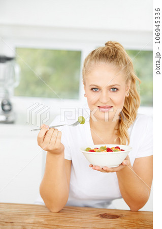 Fruit salad, eating or portrait of happy woman with a snack, morning breakfast or lunch diet in home kitchen. Face, gut health or girl with fruits, grapes or food bowl meal to lose weight or wellness Fruit salad, eating or portrait of happy woman with a snack, morning breakfast or lunch diet in home kitchen. Face, gut health or girl with fruits, grapes or food bowl meal to lose weight or wellness 106945336