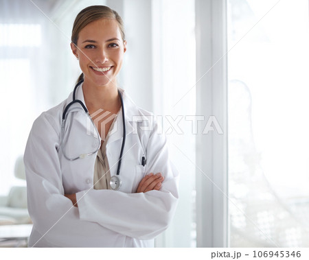 Put your trust in her. Portrait of an attractive young doctor standing with her arms folded. Put your trust in her. Portrait of an attractive young doctor standing with her arms folded. 106945346