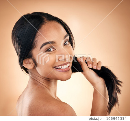 Portrait, strong hair and beauty with a woman in studio on a brown background for shampoo treatment. Face, salon and haircare with a happy young female model looking confident about natural cosmetics Portrait, strong hair and beauty with a woman in studio on a brown background for shampoo treatment. Face, salon and haircare with a happy young female model looking confident about natural cosmetics 106945354