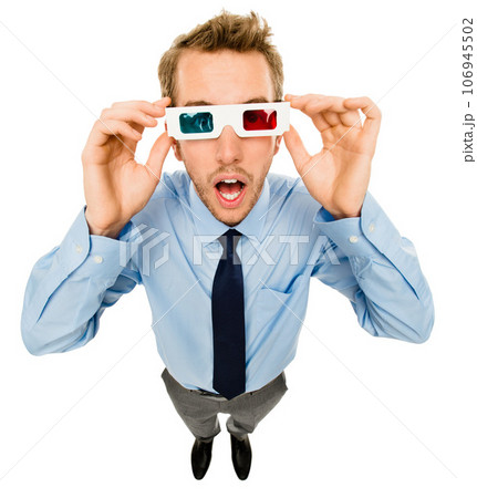 Take a look at the world around you. Shot of a young businessman wearing 3D glasses against a studio background. Take a look at the world around you. Shot of a young businessman wearing 3D glasses against a studio background. 106945502