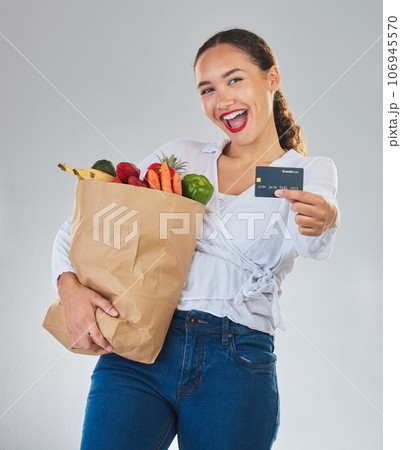 Credit card, portrait and woman grocery shopping online for fruits in studio isolated on a white background. Sustainable bag, food and excited customer with digital money, ecommerce and fintech sales Credit card, portrait and woman grocery shopping online for fruits in studio isolated on a white background. Sustainable bag, food and excited customer with digital money, ecommerce and fintech sales 106945570