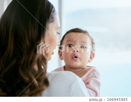 Baby, portrait and mom in a home with newborn, care and parent love together feeling curious. Face, family and young child with mother back in a living room in house with mama and childcare in lounge 106945985