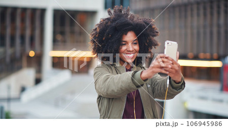 Black woman, city and selfie with afro, phone or smile for social media profile picture. Happy gen z girl, influencer or smartphone for blog, post or networking app on rooftop balcony for travel 106945986