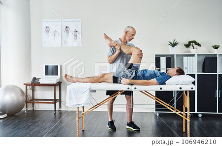Healing, physiotherapist or patient with healthcare, leg injury or recovery with wellness, care or stretching. Male person, customer or chiropractor with physical therapy, rehabilitation or knee pain Healing, physiotherapist or patient with healthcare, leg injury or recovery with wellness, care or stretching. Male person, customer or chiropractor with physical therapy, rehabilitation or knee pain 106946210