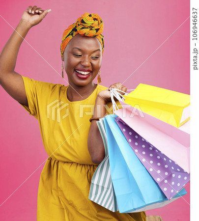 Shopping, smile and black woman with bags, excited and retail on a pink studio background. African person, customer and model with luxury items, expensive clothes and boutique products with wealth Shopping, smile and black woman with bags, excited and retail on a pink studio background. African person, customer and model with luxury items, expensive clothes and boutique products with wealth 106946637