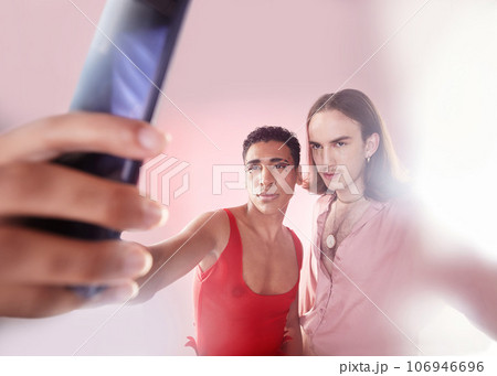 Gen z, selfie and men with style, fashion and friends with mockup, confident and studio background. Gay, queer people and guys with smartphone, capture moment and picture with edgy and trendy clothes 106946696