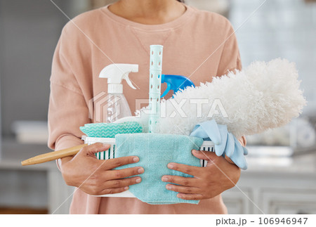 Keeping your house clean will keep you healthy too. Closeup shot of an unrecognisable holding a basket with cleaning supplies at home. Keeping your house clean will keep you healthy too. Closeup shot of an unrecognisable holding a basket with cleaning supplies at home. 106946947