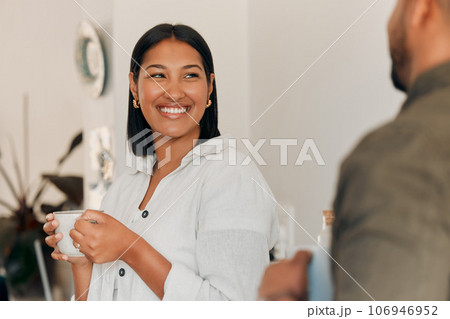 Woman drinking coffee, having conversation and bonding with her husband at home. Smiling, happy and relaxed wife enjoying quality time, romantic and peaceful moment as a couple in loving relationship 106946952