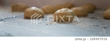 Ball shaped pastry dough for bread or donut resting and rising 106947016