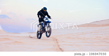 Sand, desert or athlete driving motorcycle for action, adventure or fitness with performance or adrenaline. Rally, sports or person on motorbike on dunes for training, exercise or race or challenge 106947030