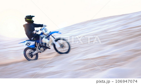 Motorbike, desert and fast man training for sports, motion blur or travel journey outdoor. Motorcycle, speed and driver on sand, dirt and off road for freedom, race challenge and extreme competition 106947074