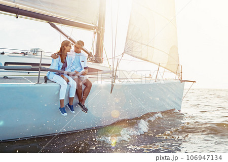 Happy couple, ship and cruise for hug, ocean or summer sunshine for love, romance or outdoor adventure. Man, yacht and woman with waves, bonding or peace for luxury, lifestyle and travel for holiday 106947134