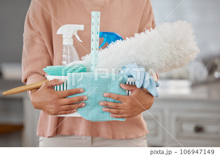 Lets do some spring cleaning. Closeup shot of an unrecognisable holding a basket with cleaning supplies at home. 106947149