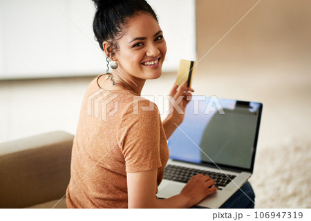 Woman with smile, laptop and credit card with online shopping and payment on store website with fintech. Young female person at home, portrait and happy with internet banking, finance and ecommerce Woman with smile, laptop and credit card with online shopping and payment on store website with fintech. Young female person at home, portrait and happy with internet banking, finance and ecommerce 106947319