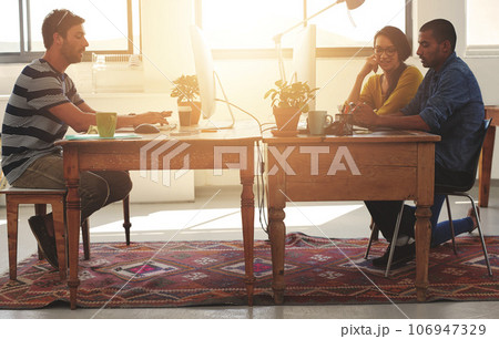 Coworking, web designer and team in office with work and lens flare of small business. Startup, teamwork and staff in a workplace with communication of tech group with website design for project Coworking, web designer and team in office with work and lens flare of small business. Startup, teamwork and staff in a workplace with communication of tech group with website design for project 106947329