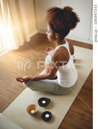 Calm woman, meditation and zen for yoga, spiritual wellness or healthy exercise at home. Female yogi relaxing or meditating on mat in mental wellbeing, mindfulness or awareness for health and fitness 106947333