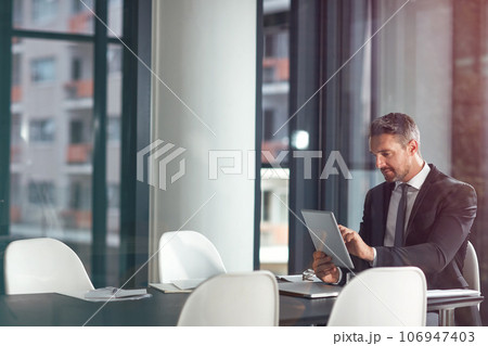 Tablet, typing and business man planning in office, conference room or glass reflection, data analysis and software. Professional person or corporate office CEO search analytics on digital technology 106947403