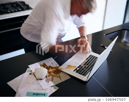 Laptop, documents and man spill coffee, mistake or accident in home kitchen. Angry, spilling tea on computer and paper of mature male person, freelancer or remote worker with error, problem or clumsy Laptop, documents and man spill coffee, mistake or accident in home kitchen. Angry, spilling tea on computer and paper of mature male person, freelancer or remote worker with error, problem or clumsy 106947507