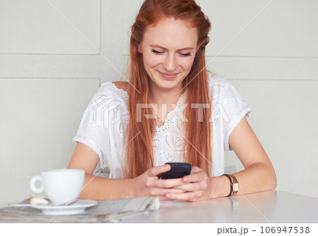 Coffee shop, phone and happy woman texting, relax and smile for chat app on wall background. Cafe, social media and female customer reading post, news or update while enjoying day off and tea break Coffee shop, phone and happy woman texting, relax and smile for chat app on wall background. Cafe, social media and female customer reading post, news or update while enjoying day off and tea break 106947538